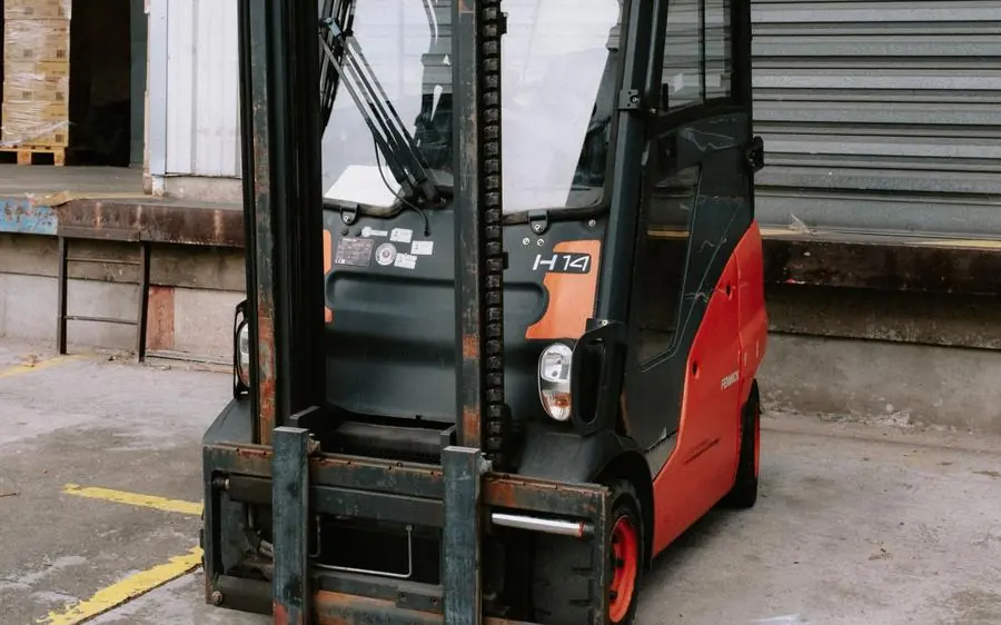 Red and black forklift at a warehouse dock